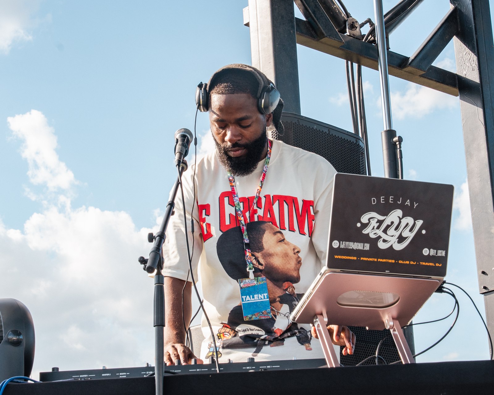 DJ FLYY performing at an outdoor festival event