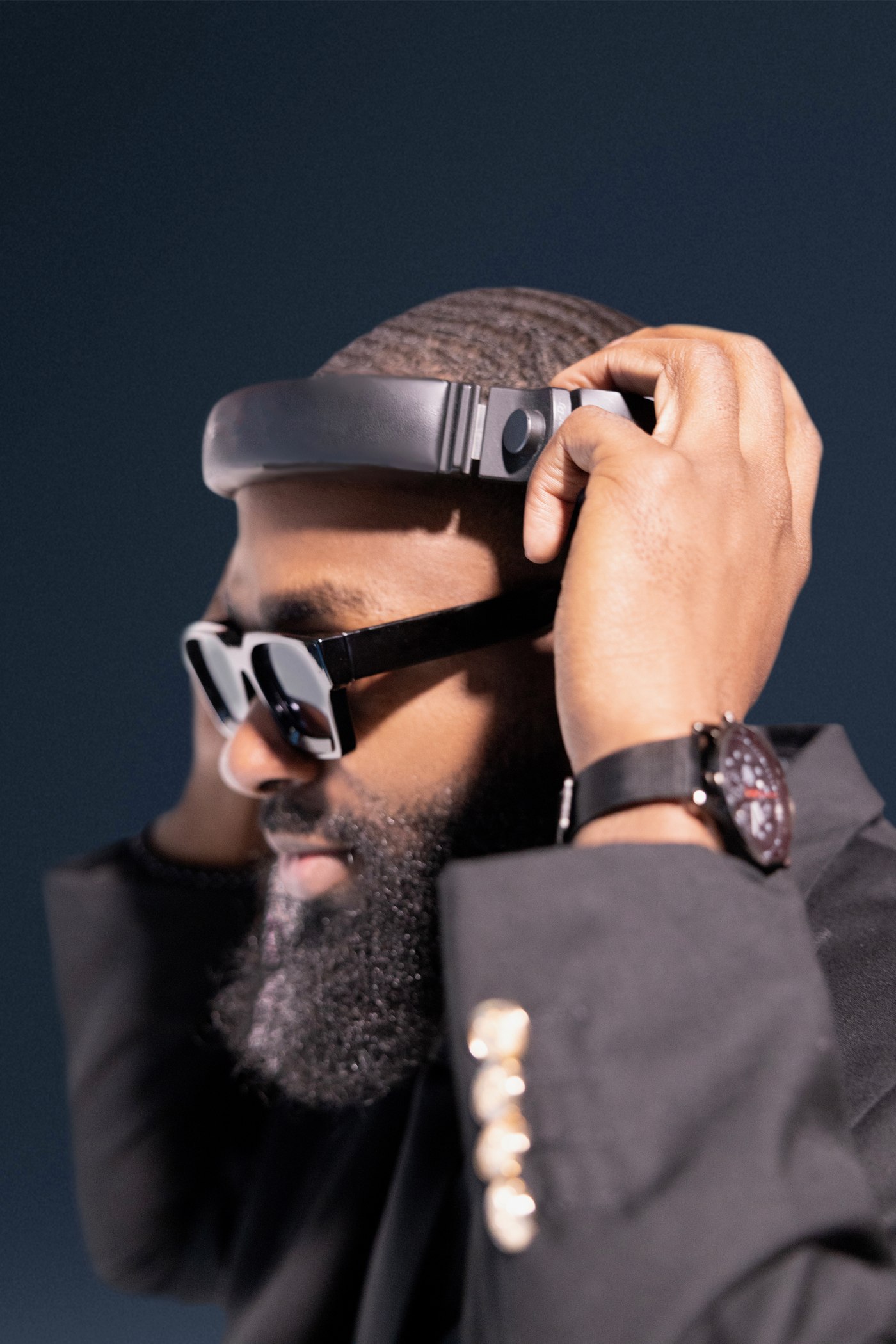 DJ FLYY adjusting his headphones, studio portrait
